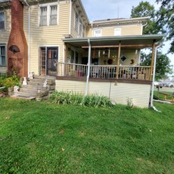 A 1 Roofing Renovation and Construction - Downspout above deck roof to be removed and moved to the other gutter.