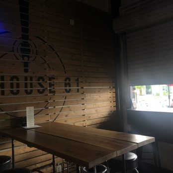 TapHouse 61 - a table and stools in front of a window - Beer Bar Near Me - Saint Petersburg, Florida