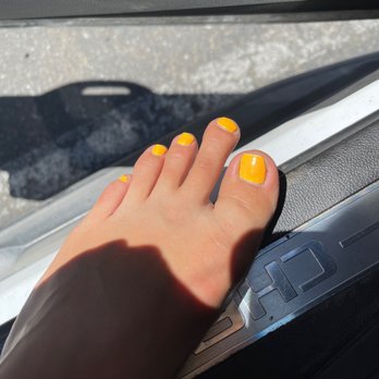 Lovely Nails - Epic fail of a relaxing, bright yellow pedicure. My nail is crooked & he used like 3 layers of white beneath this weird color. - Nail Salons Near Me - Modesto, California