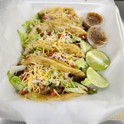 Grubbz - Steak tacos on crispy corn tortillas, piled with lettuce, cilantro, onion, pico & fiesta cheese, with grilled jalapeños and salsa.