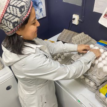 Community Cupboard Mend - Employee Alexandra Muro repackages eggs for distribution to shoppers. - Food Banks Near Me - Leavenworth, Washington Community Cupboard Mend - Employee Alexandra Muro repackages eggs for distribution to shoppers. - Food Banks Near Me - Leavenworth, Washington