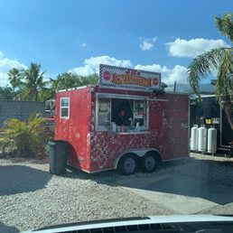 a food truck parked in a parking lot a food truck parked in a parking lot