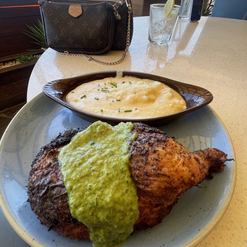 Beach House - Cilantro lime chicken with white cheddar grits - Bars Near Me - Pompano Beach, Florida Beach House - Cilantro lime chicken with white cheddar grits - Bars Near Me - Pompano Beach, Florida