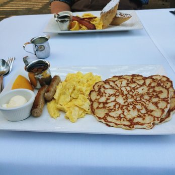Murphy's Hotel Restaurant - Forefront- pancakes, scrambled eggs, sausage, butter. Background - french toast with scrambled eggs and bacon. - American Near Me - Murphys, California