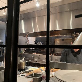 Firewood - The kitchen view, right next to our table (sharing the same wall) - New American Near Me - Park City, Utah Firewood - The kitchen view, right next to our table (sharing the same wall) - New American Near Me - Park City, Utah