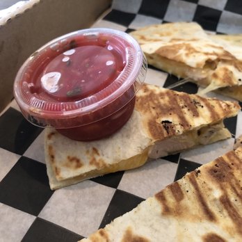 The Southern Grind Coffee House - Chicken quesadilla size comparison with a small salsa cup - Coffee & Tea Near Me - Orange Beach, Alabama