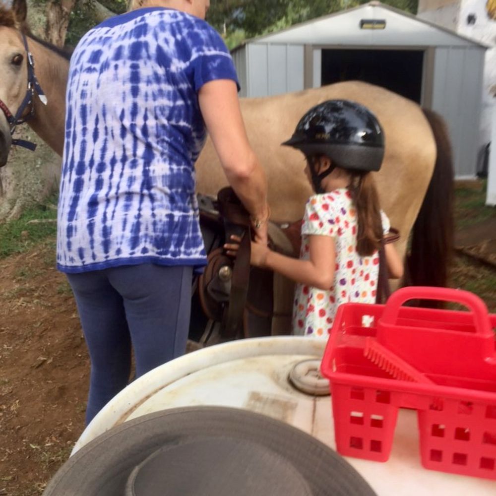 Aloha Riding Lessons - Teaching rider how to saddle up and take saddle off the horse after the lesson. - Horseback Riding Near Me - Honolulu, Hawaii
