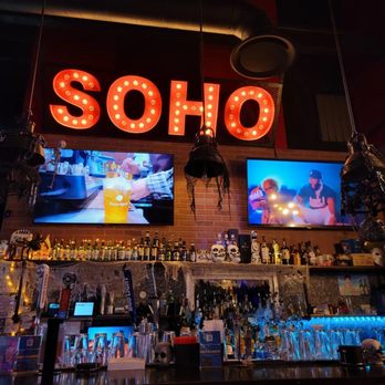 Soho Chicken - a bar with a large neon sign above the bar - Korean Near Me - Houston, Texas