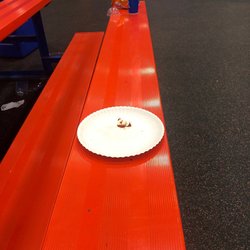 Sky Zone Trampoline Park - A plate left on the bench and drinks and chip bags
