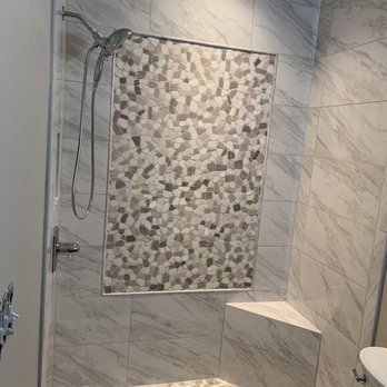 On Point Flooring - Custom tile installation with corner seat in a small bathroom and designed to make the space look larger - Flooring Near Me - Concord, North Carolina