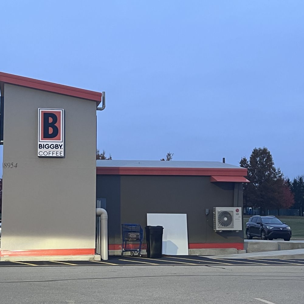 a parking lot with a coffee shop a parking lot with a coffee shop