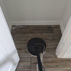 Courteous Carpet Care - Professional hard surface and wood-look tile floor cleaning in progress, restoring a deep, clean shine to the hallway.