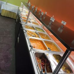 Cinnamon Bistro Indian Cuisine - Buffet Table As of 1/21/24 Adult $16.99 dinners/weekends Kids (up to 8 yrs) is $8.99. (8yrs + is considered as an adult)
