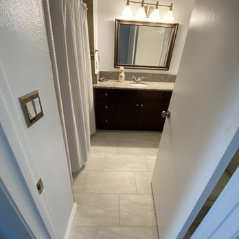 JC Tiles - a view of a bathroom from the hallway - Flooring Near Me