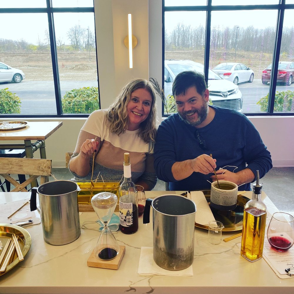 Pouring our own candles while enjoying a bottle of wine.