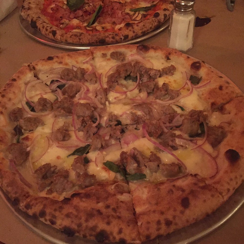 Santa Panza - Italian sausage pizza and the front and a meat and mushroom one in the back. - Pizza Near Me - Brooklyn, New York