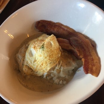 Marble The Steakhouse - Sausage and biscuit topped with an egg and side bacon. Perfect! - Steakhouses Near Me - Kokomo, Indiana
