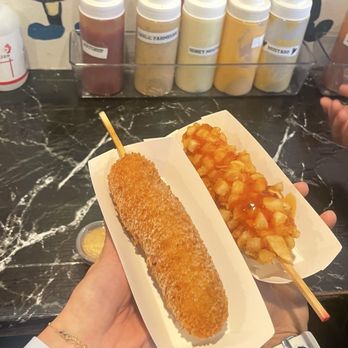 Chung Chun Rice Dog Mochinut - Volcano Hot Dog(black) & Potato Mozzarella (red) - Korean Near Me - Seattle, Washington Chung Chun Rice Dog Mochinut - Volcano Hot Dog(black) & Potato Mozzarella (red) - Korean Near Me - Seattle, Washington