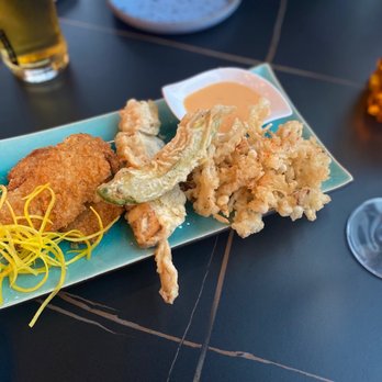 Shushuto - a plate of food and a glass of beer - Tapas Bars Near Me - Montreal, Quebec