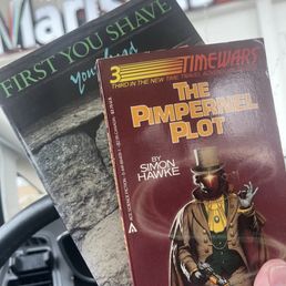 Two cool used books in front of the store sign. Two cool used books in front of the store sign.
