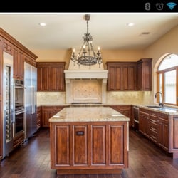 Gold Coast Electric Services - Chandelier, cans and undercover lighting in the kitchen.