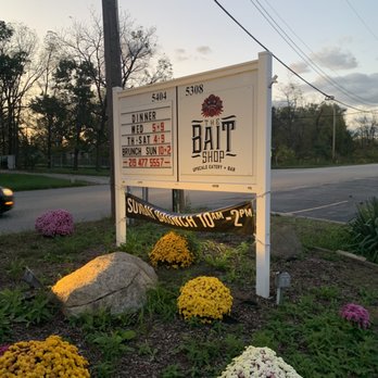 The Bait Shop - a sign and flowers in the foreground - Bars Near Me - Valparaiso, Indiana