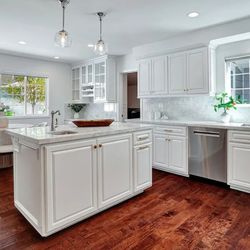 D L R Construction - Elegant marble backsplash complements the freshly painted white cabinets, now updated with sleek new hardware for a clean, modern look.