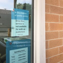 a sign in the window of a pharmacy