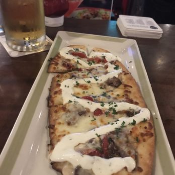 99 Restaurants - Steak n cheese flatbread w a cold brew, part of the $5 apps during non peak hours - Pubs Near Me - Mashpee, Massachusetts