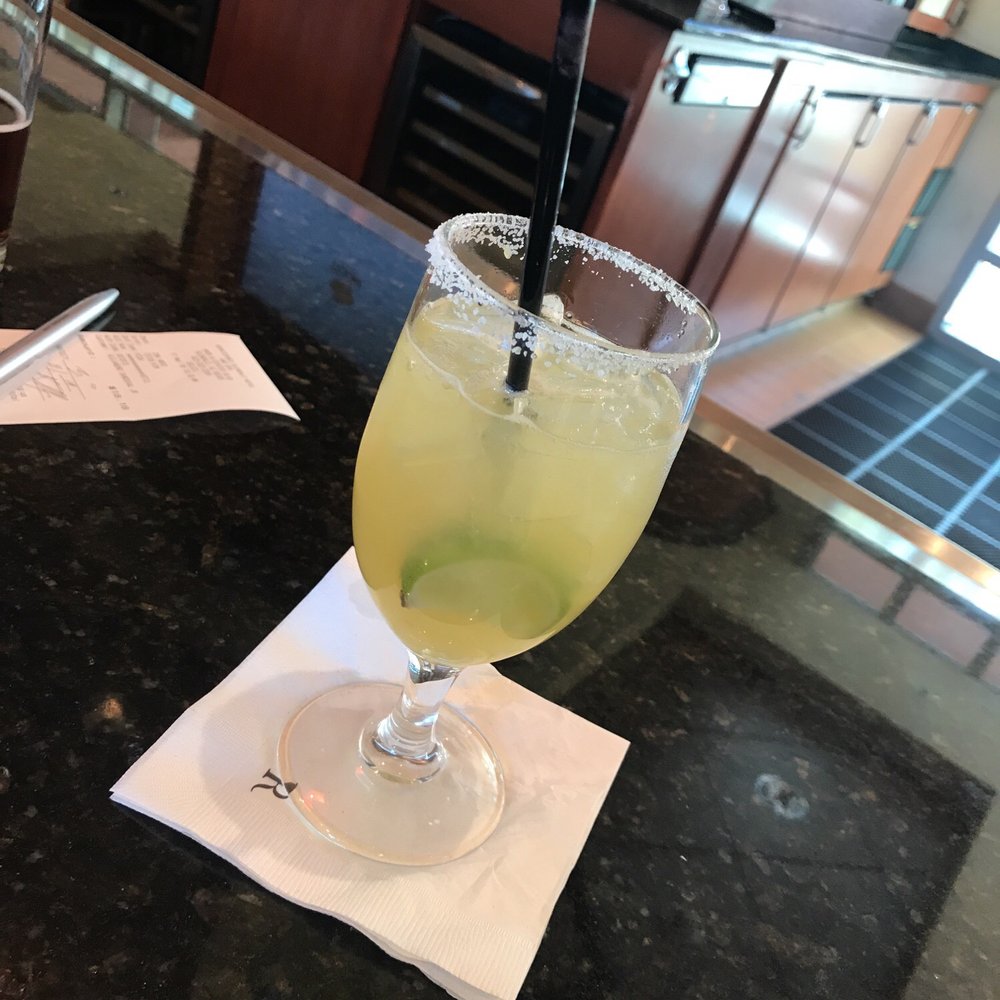 a glass of lemonade on a napkin