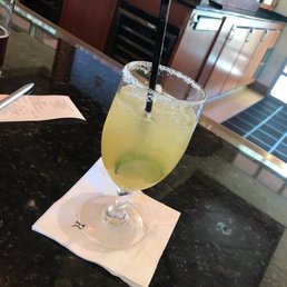 a glass of lemonade on a napkin