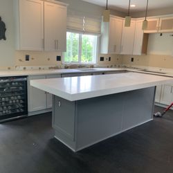 Wholesale Granite Marble & Tile - Arctic white quartz mitered edge island.