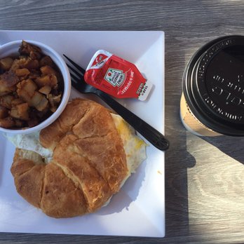 Pressed Cafe Burlington - Egg and cheese on croissant with a side of potatoes and coffee. - Breakfast & Brunch Near Me - Burlington, Massachusetts
