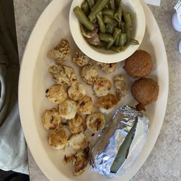 "Large" fried oyster and grilled scallop combo with green beans, baked potato, and hush puppies. "Large" fried oyster and grilled scallop combo with green beans, baked potato, and hush puppies.