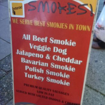 Holy smokes - a sign on the sidewalk - Street Vendors Near Me - Vancouver, British Columbia