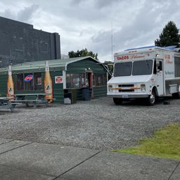 two food trucks parked in a parking lot two food trucks parked in a parking lot