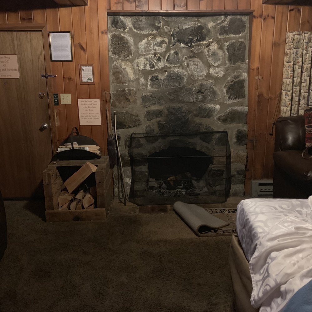This is the upgraded room we were told we were getting - notice the rug pulled back in front of the fireplace - and our made bed This is the upgraded room we were told we were getting - notice the rug pulled back in front of the fireplace - and our made bed