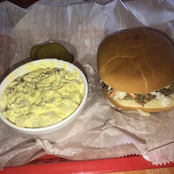 Prater's BBQ - Pulled pork sandwich with coleslaw on it and potato salad. - Barbeque Near Me - Morrison, Tennessee