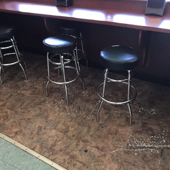 La Isla Deli - a row of bar stools in front of a window - Delis Near Me - Patchogue, New York