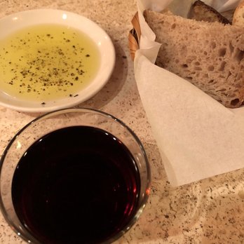 Chez Lulu - Olive oil and a basket of assorted breads from The Continental Bakery and a glass of Pinot noir. - French Near Me - Birmingham, Alabama Chez Lulu - Olive oil and a basket of assorted breads from The Continental Bakery and a glass of Pinot noir. - French Near Me - Birmingham, Alabama