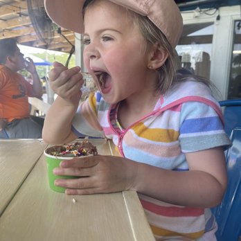 Blue Goat Kitchen & Refreshments - Amelia enjoying chocolate ice cream with sprinkles - Bars Near Me - Lanett, Alabama Blue Goat Kitchen & Refreshments - Amelia enjoying chocolate ice cream with sprinkles - Bars Near Me - Lanett, Alabama