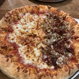 Thick crust pizza with some bacon and sausage Thick crust pizza with some bacon and sausage