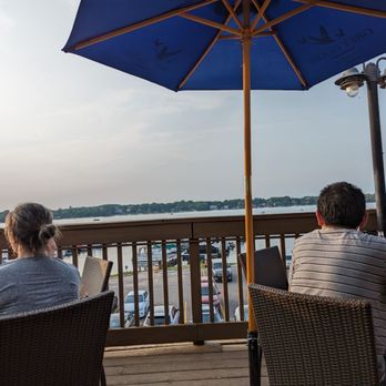 Docks Bar & Grill - people sitting at tables with umbrellas - American Near Me - Wauconda, Illinois