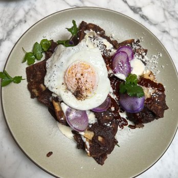 Manuela - Black Beans Chilaquiles, Crema, Fried Egg, Radish, Cilantro, Queso Fresco - New American Near Me - Los Angeles, California Manuela - Black Beans Chilaquiles, Crema, Fried Egg, Radish, Cilantro, Queso Fresco - New American Near Me - Los Angeles, California
