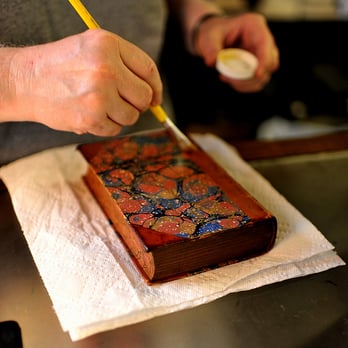 Beckham's Book Shop - The proprietor doing some care on the leather of an old volume - Bookstores Near Me - New Orleans, Louisiana Beckham's Book Shop - The proprietor doing some care on the leather of an old volume - Bookstores Near Me - New Orleans, Louisiana