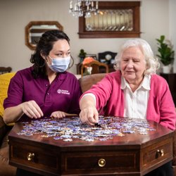 Home Instead - CarePro and client enjoying a puzzle