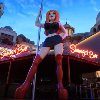 Showgirl Bar - a woman standing on a pole in front of a building - Bars Near Me - Las Vegas, Nevada Showgirl Bar - a woman standing on a pole in front of a building - Bars Near Me - Las Vegas, Nevada