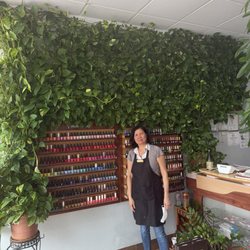 The owner and the amazing plant wall her husband maintains from just 2 plants. She is so sweet !