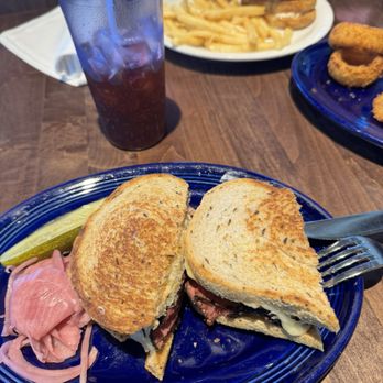 The Refuge - Reuben, Black Cherry Soda, Tuna Melt in the background with a side of truffle fries, and Onion Rings - Burgers Near Me - San Mateo, California The Refuge - Reuben, Black Cherry Soda, Tuna Melt in the background with a side of truffle fries, and Onion Rings - Burgers Near Me - San Mateo, California
