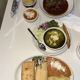 Chicken mole, green chicken pozole, beef chimichanga and corn tamale